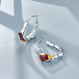 CYNTHIA Two-tone hoop earrings with garnet